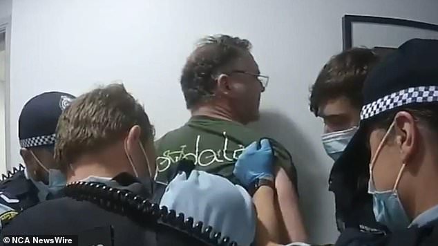 The former TV presenter was handcuffed in the hallway by New South Wales Police. Photo: Nine News