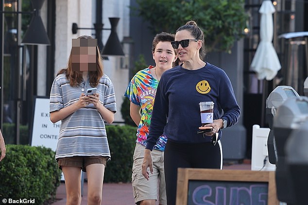 As she stopped by an ATM to withdraw some cash, the Golden Globe winner, who made a playful reference to her ex-husband Ben Affleck in Deadpool & Wolverine, had her hands full as she carried an iced coffee, car keys and her iPhone.