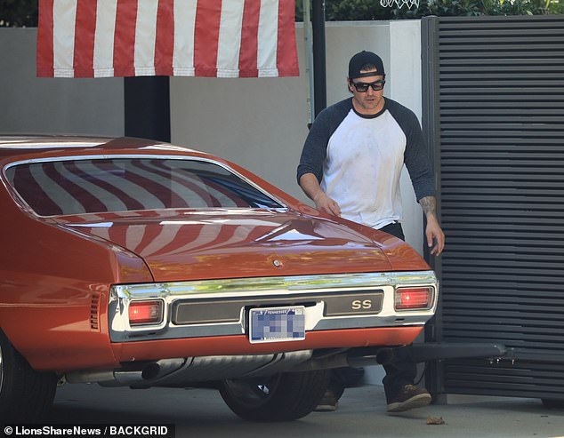 He was seen with his elegant red vintage Chevelle.