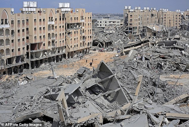 The Democratic Party has been divided by the war between Israel and Hamas. Pictured: Displaced Palestinians walk through a rubble-strewn street in the Hamad area in the southern Gaza Strip