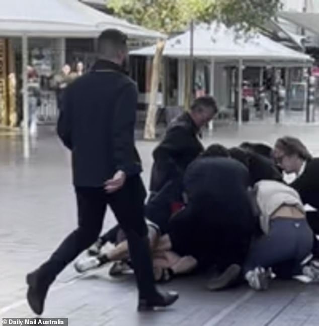 Bystanders rushed to hold one of the fighters on the ground while a woman screamed for the police to be called.