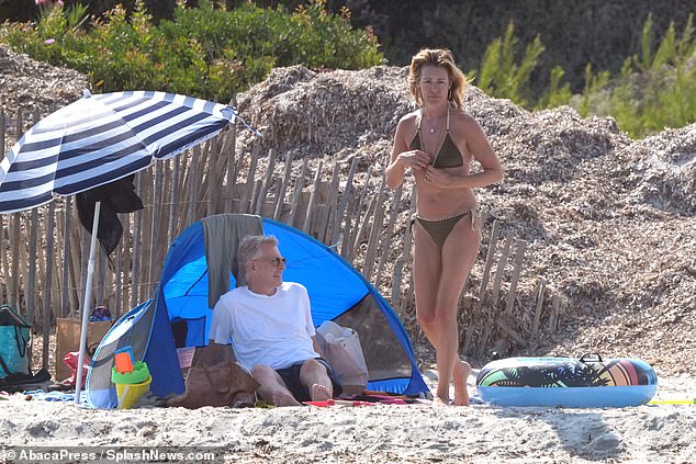 Cat and Patrick sat on the beach with their striped umbrellas and a tent to protect them from the shade.