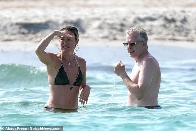 The couple looked in love as they took a romantic dip in the sea.