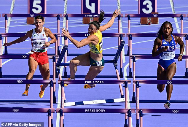 She knocked over the obstacle but fell after losing her balance and landing hard on her side.