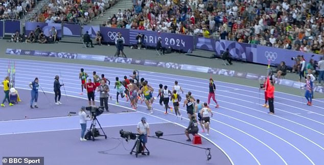 He seemed blissfully unaware of what was happening as the athletes ran straight past him.