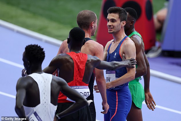 Hugo Hay of Team France and George Mills of Team Great Britain chat after competing in the men's 5000m.