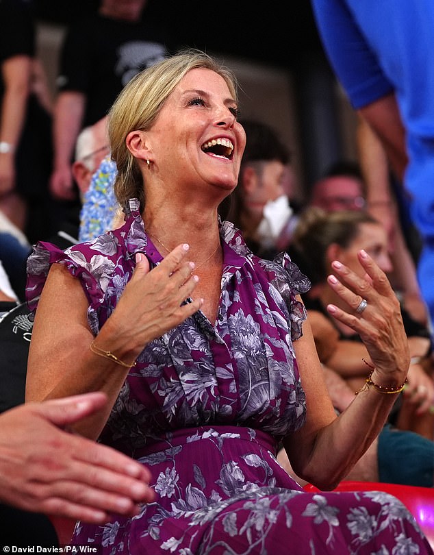 The royal looked summery in a purple floral dress that featured a long pleated skirt and ruffled sleeves as she cheered on the team from the sidelines.