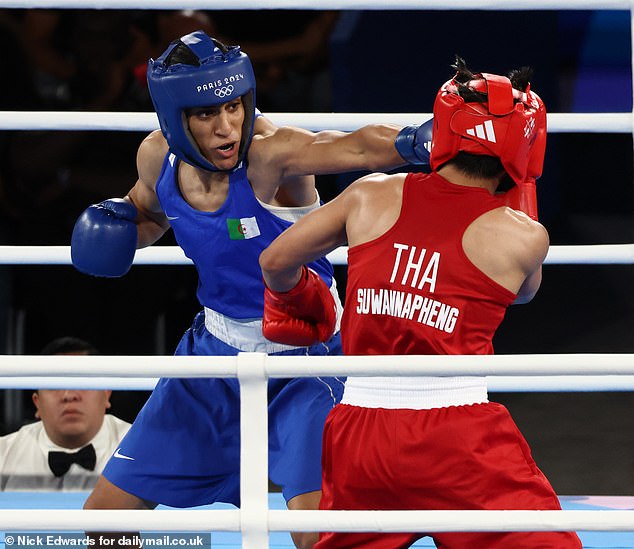 Imane Khalif punches Janjaem Suwannapheng in the face during the women's 66kg boxing semi-final at the 2014 Paris Olympics