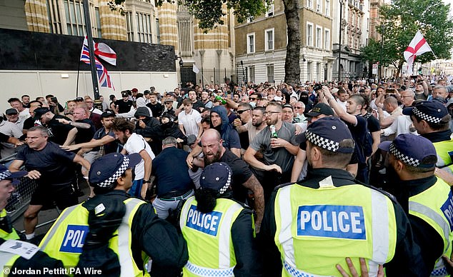 Nearly 6,000 law enforcement officers have been deployed to respond to the unrest, police sources have told the BBC. Pictured: Police officers confront protesters during the protest 