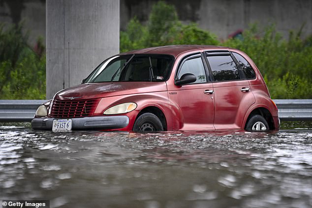 A vehicle was trapped on a flooded street due to Tropical Storm Debby on August 6 in Charleston.