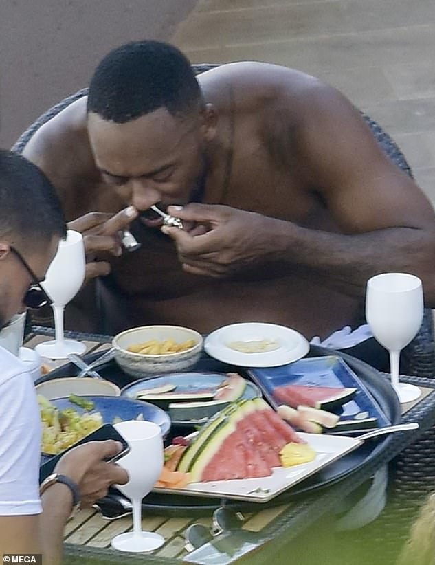 The son of NBA great Michael Jordan looked focused as he sniffed the powder while his glamorous bikini-clad partner smiled and chatted next to him and friends ate lunch across the table.