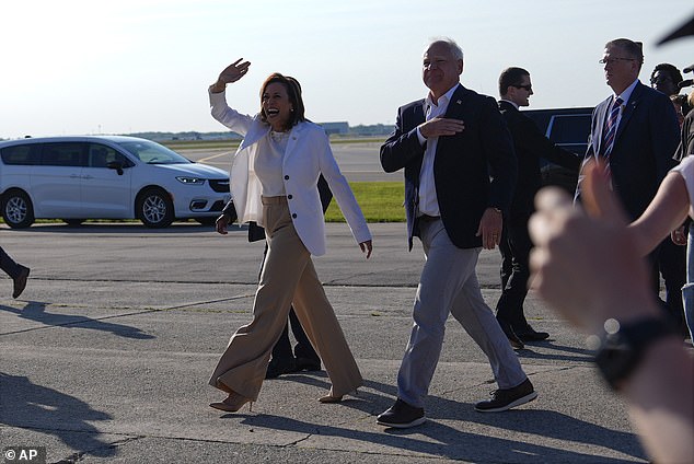 Harris and Walz walk down the runway of Air Force Two toward the rally site.