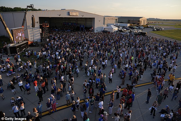 The crowd of 15,000 people emerged from the hangar.