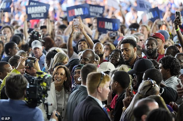 Kamala Harris takes photos with the crowd after her remarks