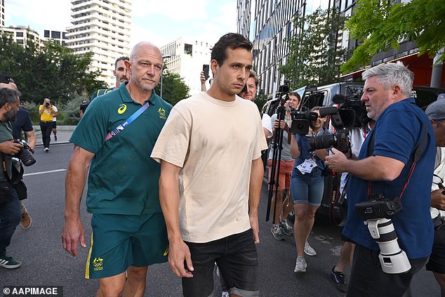 The 28-year-old is pictured with Australian Hockey's head of high performance Bernard Savage (left) on his way to tell the media he had made a mistake 