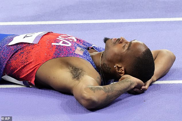 Hall took a moment to savour his victory as he lay back on the track after his 400m final victory.