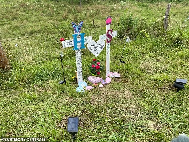 A memorial filled with large white crosses has been erected at the site of the accident in honour of the sisters.