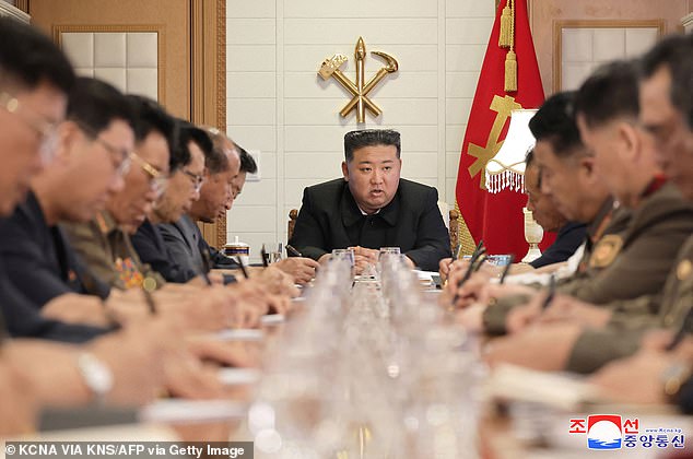 North Korean leader Kim Jong Un is pictured holding an emergency meeting to discuss flood restoration measures in North Korea