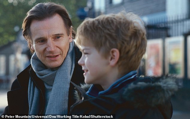 Liam Neeson and Thomas Sangster in Love Actually. Curtis is known for making romantic comedies, including Four Weddings and a Funeral, Notting Hill and About Time.