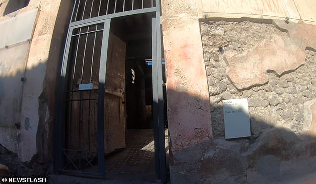 The entrance to the ancient villa, which is a popular spot for tourists visiting the site.