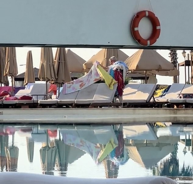 TikTok user The Railway Queen shared a video showing a manager at her hotel in Turkey stacking towels over his shoulder in an attempt to clear space by the pool.