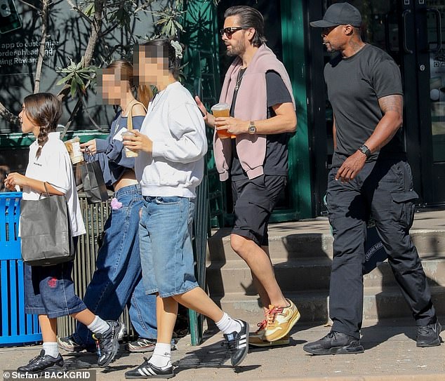 He cut a casual California figure as he was spotted with his baby daughter on Wednesday, pairing a black T-shirt with matching shorts.