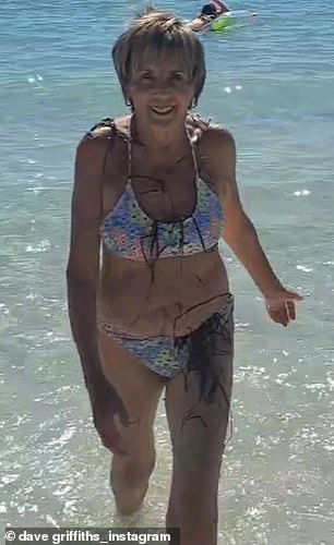 The Channel 4 favourite, 67, who was filmed on holiday by her husband Dave, cut a stylish figure in a multi-coloured bikini as she emerged from the water.