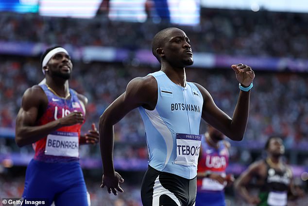 Botswana's Letsile Tebogo celebrates winning the gold medal in the 200m final