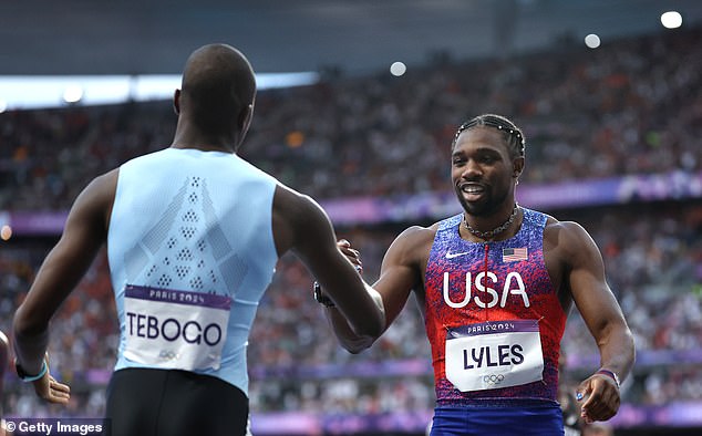 Gold medalist Letsile Tebogo of Team Botswana is congratulated by Noah Lyles of Team USDA