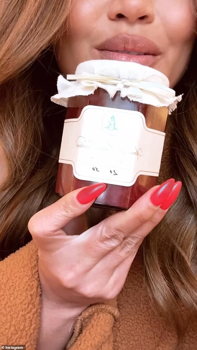 American model and television personality Chrissy Teigen poses with a jar of Meghan Markle's jam