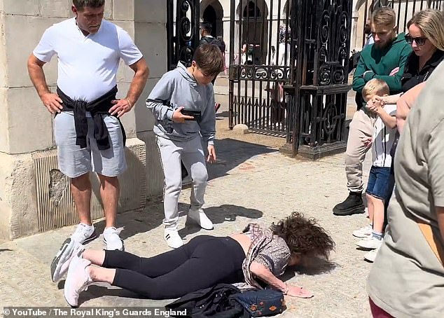 Another woman was allegedly thrown to the pavement by one of the Royal Guard's horses.