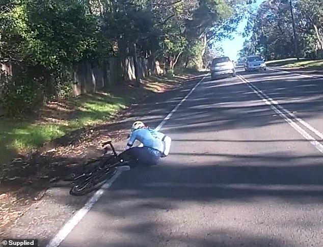 The cyclist who took the dashcam footage said the cyclist was left lying on the ground, but a car behind them stopped to help her.