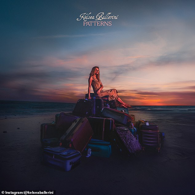 The blonde beauty revealed the album's cover art, which is a moody snap of her sitting on a pile of luggage on a beach as the sun sets.