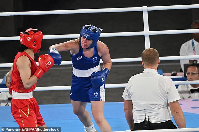 Caitlin Parker (in blue) became the first Australian boxer to win a medal when she claimed bronze after losing to China's Li Qian (in red).