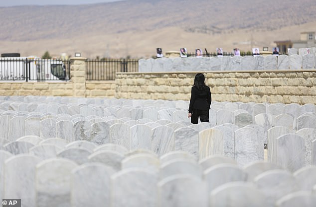 A Yazidi woman visits her relatives at a cemetery during the commemoration in Sinjar on August 3.