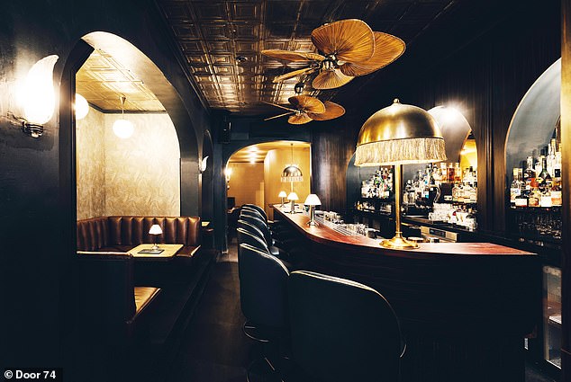 Gate 74 - Amsterdam: The interior of this hidden bar features dark leather seating, wooden tables and tasseled lamps.