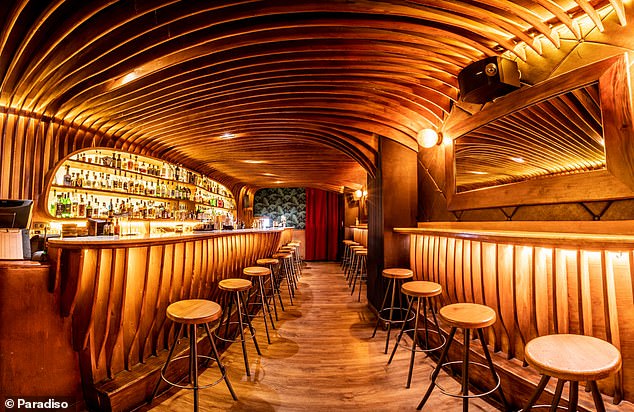 The interior of Paradiso (pictured) is clad in wood that elegantly weaves across the bar and ceiling.