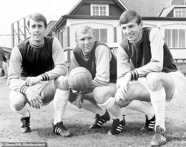 Geoff Hurst (left) and Martin Peters (right) won the World Cup with captain Moore in 1966