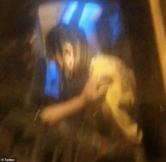 The images show Scott in the back of a French police car with his hands behind his back.