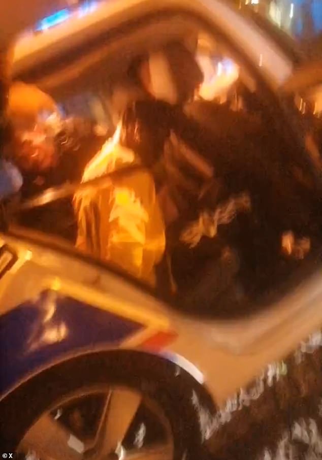 The rapper was handcuffed in the back of a French police car on Friday morning