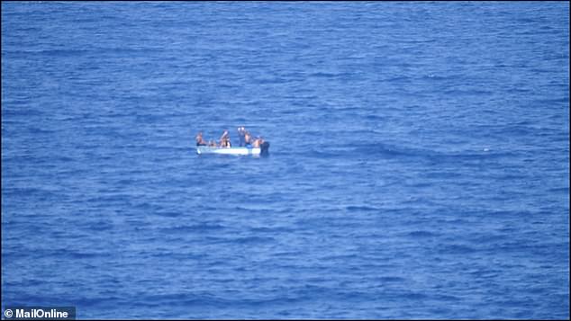 The cruise ship's captain alerted Spanish authorities, who guided the small boat (pictured), carrying about eight people, to shore at around 4:30 p.m. local time.