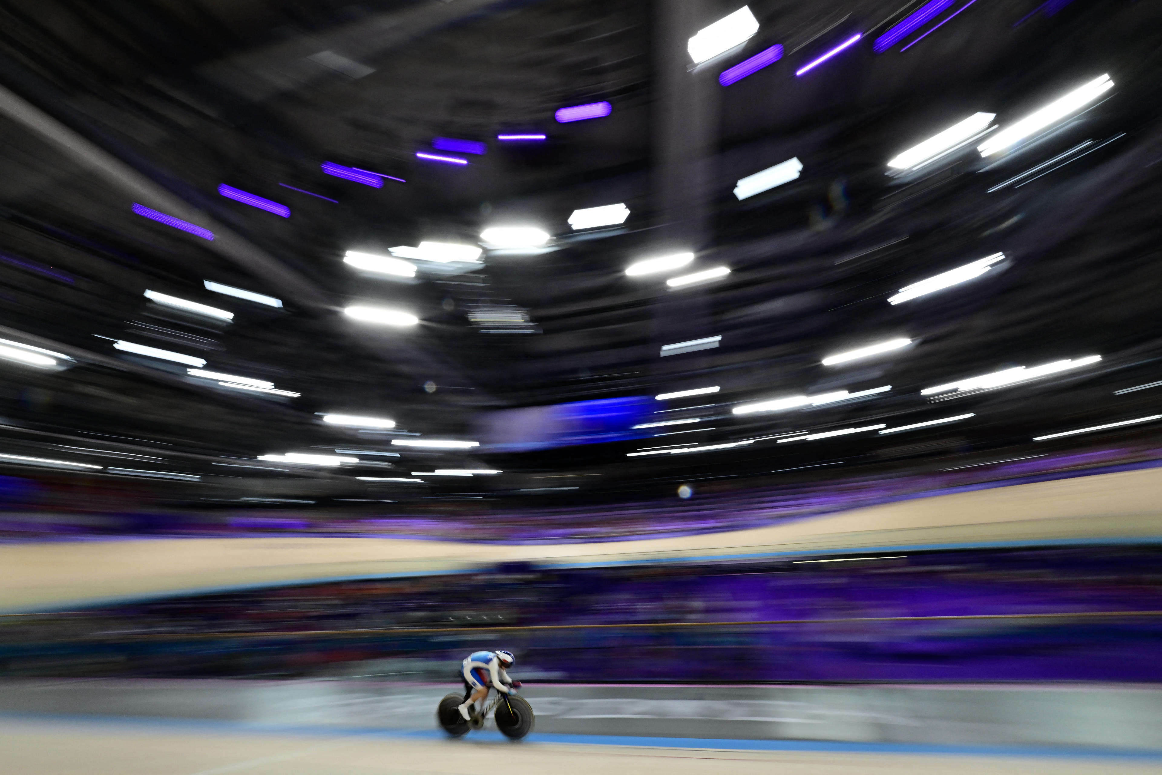 France's Mathilde Gros competes in the women's track cycling qualifying round for the Paris 2024 Olympic Games at the Velodrome National de Saint-Quentin-en-Yvelines in Montigny-le-Bretonneux, southwest of Paris, on August 9, 2024. (John MacDougall/AFP/Getty Images)