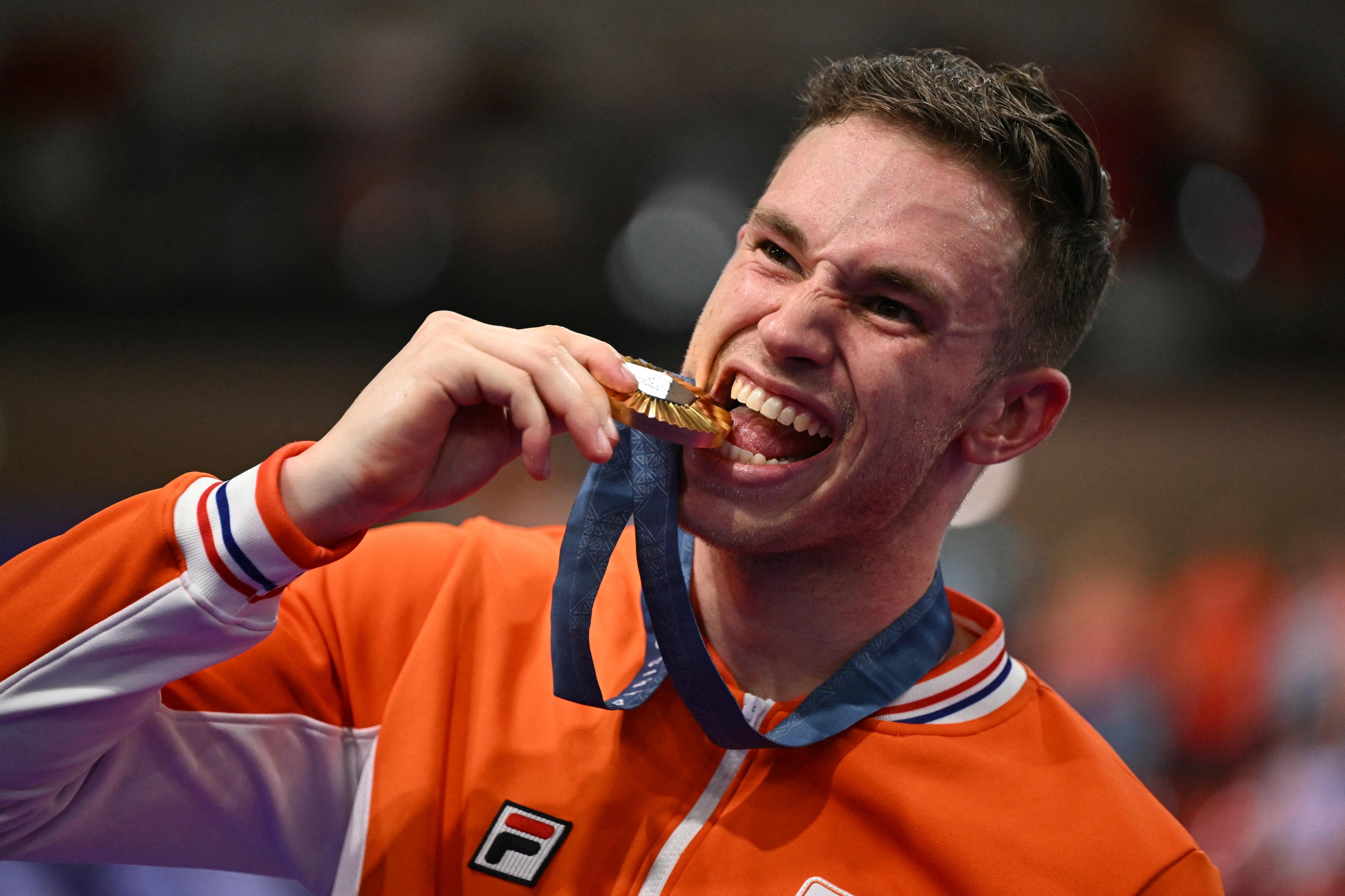 Gold medallist Harrie Lavreysen of the Netherlands poses with his medal on the podium of the men's track cycling sprint event at the Paris 2024 Olympic Games at the Velodrome National de Saint-Quentin-en-Yvelines in Montigny-le-Bretonneux, southwest of Paris, on August 9, 2024. (Sebastien Bozon/AFP/Getty Images)