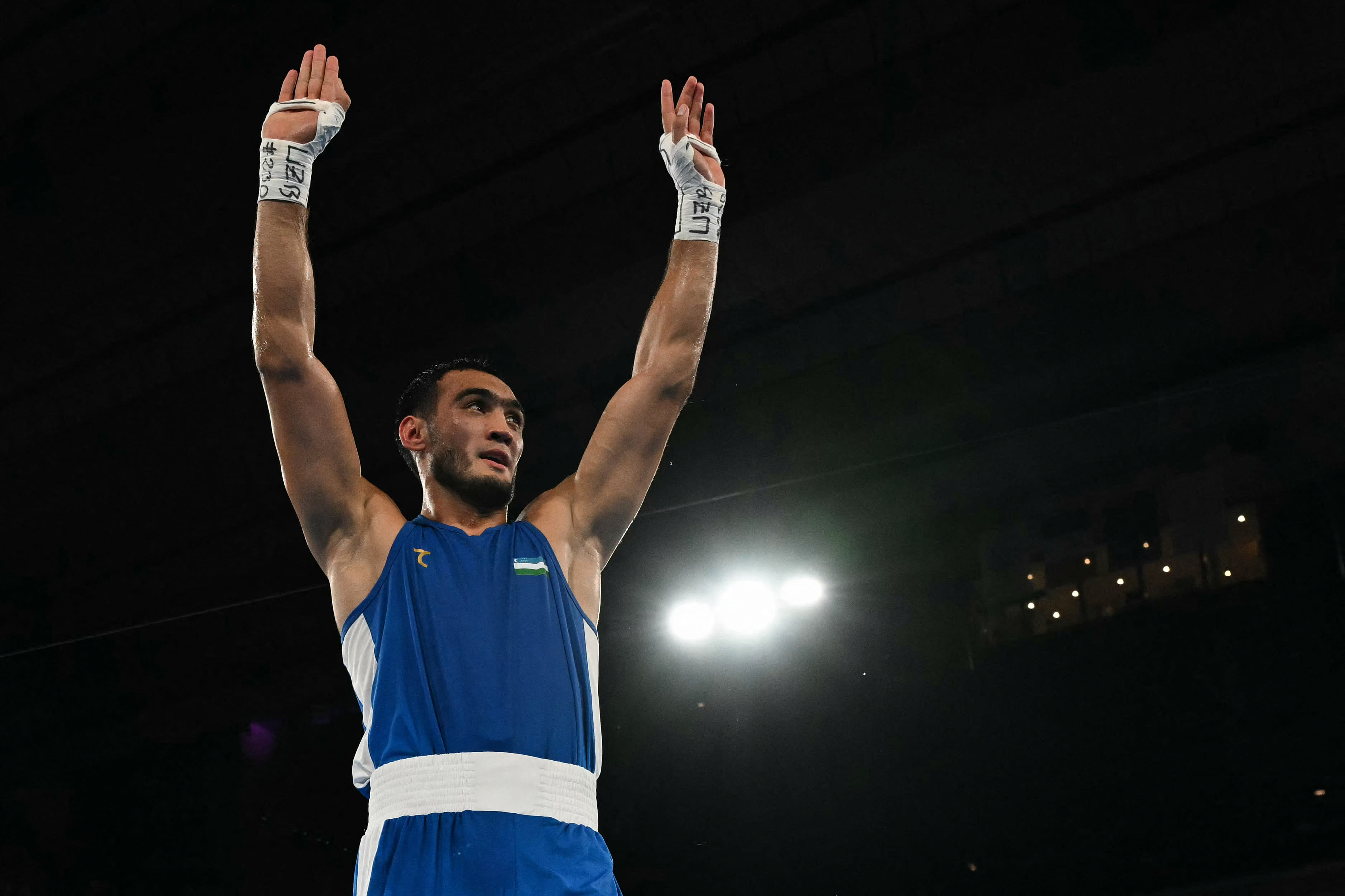 Uzbekistan's Lazizbek Mullojonov (blue) reacts after beating Azerbaijan's Loren Berto Alfonso Dominguez in the men's 92kg boxing final during the Paris 2024 Olympic Games at Roland-Garros Stadium, Paris on August 9, 2024. (Mohd Rasfan/AFP/Getty Images)