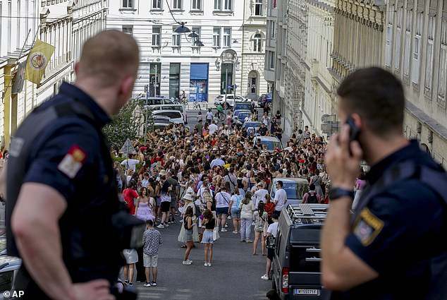 Police are seen observing the gathering in the city centre.