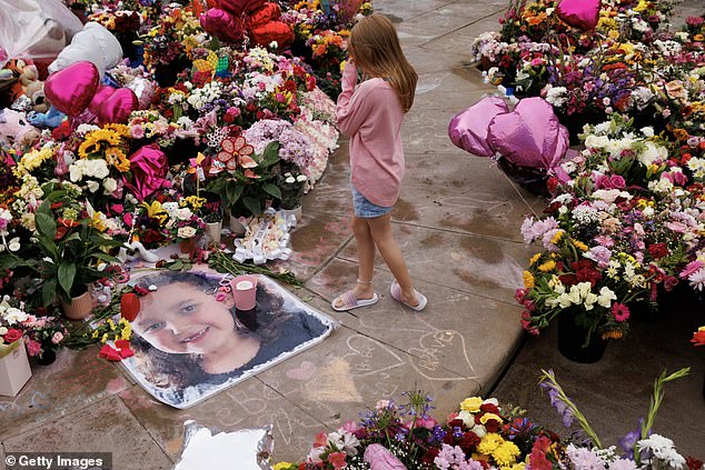 Community members arrive before a vigil to remember the victims on August 5.