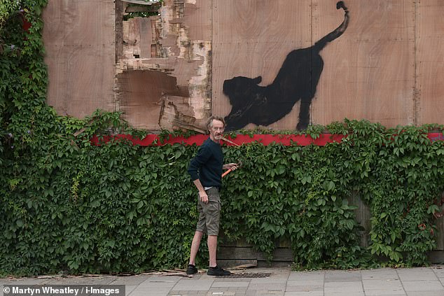 Banksy revealed his sixth piece of art in as many days on his Instagram page today at 1pm, but within an hour an opportunist was caught red-handed trying to remove it from the wall.