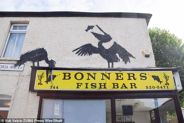 The mural is located above Bonners Fish Bar on Northcote Road. It is inspired by a quiet residential street in East London.