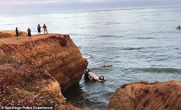 The car landed upside down in the water after Brians drove it off the cliff.