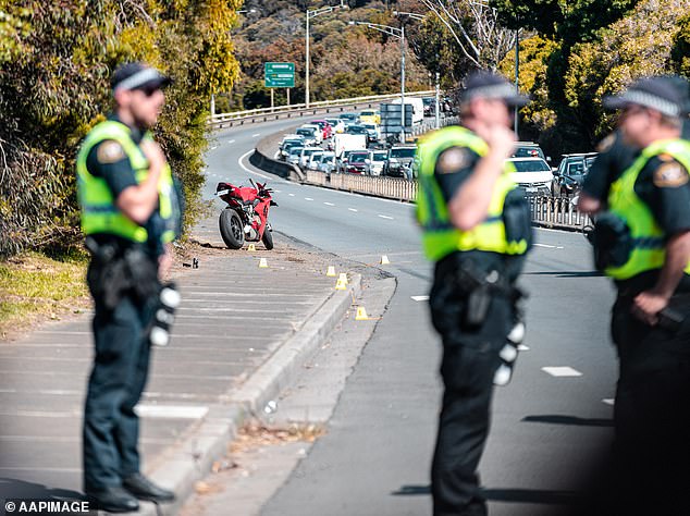 Officers have revealed that there is a particular rise in the number of motorcyclists and pedestrians killed (pictured, police at the scene of a motorcycle accident in 2022)